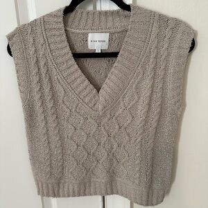 Woman’s beige cable knit vest